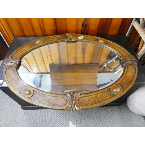 140 - A stunning oak framed oval wall mirror.