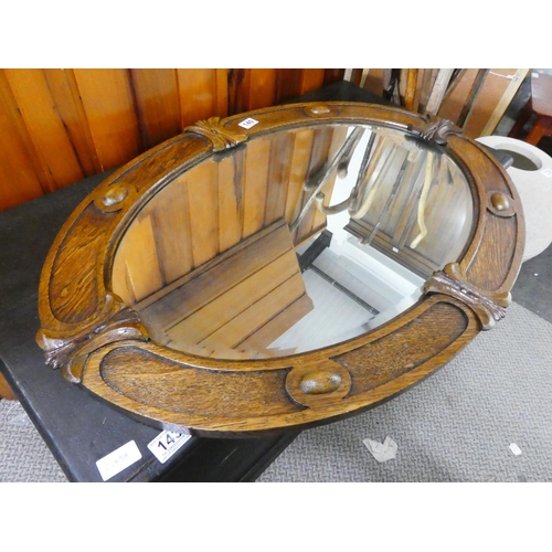 140 - A stunning oak framed oval wall mirror.