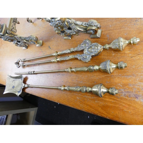 144 - A stunning antique set of heavy brass fire irons and dogs.