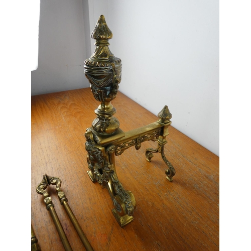 144 - A stunning antique set of heavy brass fire irons and dogs.