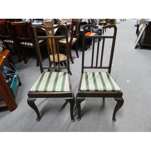 148 - A pair of mahogany rail back hall chairs.