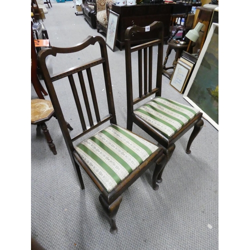 148 - A pair of mahogany rail back hall chairs.