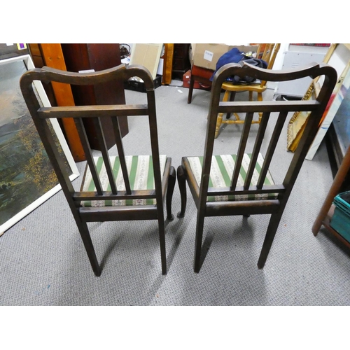 148 - A pair of mahogany rail back hall chairs.