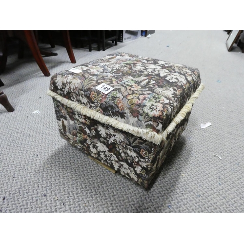 149 - An upholstered footstool on casters.