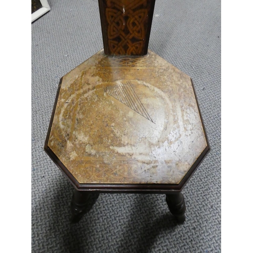 152 - An antique spinning chair with Celtic scroll and shamrock detail and depicting the picture of Monast... 