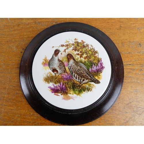 157 - A pair of mounted ceramic plaques of grouse.