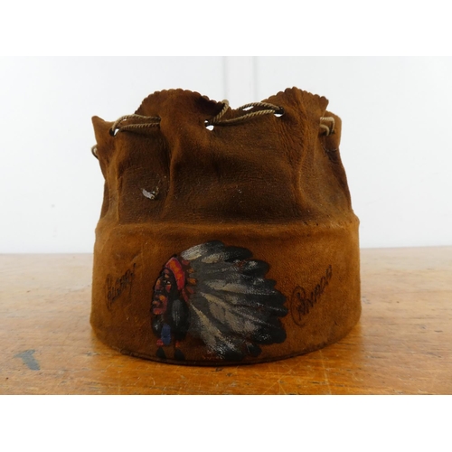 182 - A vintage suede 'Canada' sovereign drawstring bag containing belts and various pipes.