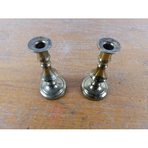 211 - A small pair of brass candlesticks.