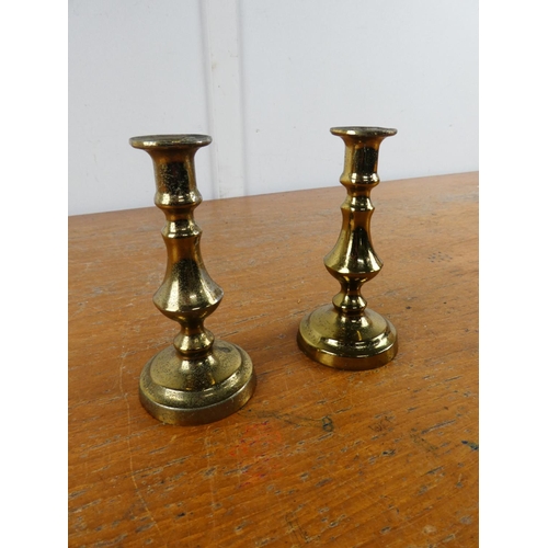 211 - A small pair of brass candlesticks.