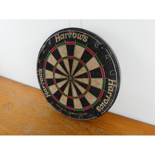 216 - A Harrows dart board.