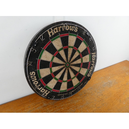 216 - A Harrows dart board.