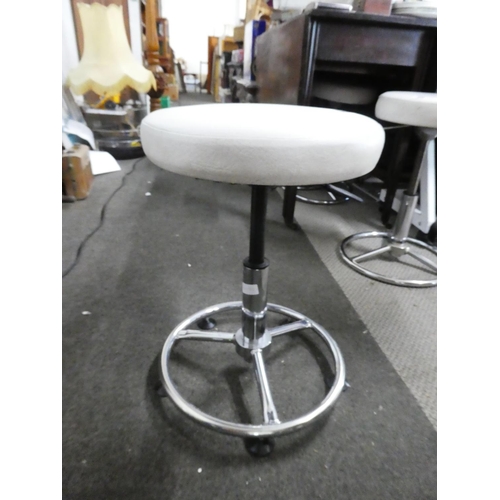 25 - A pair of leather topped swivel adjustable stools