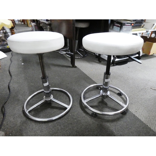 26 - A pair of leather topped swivel adjustable stools.