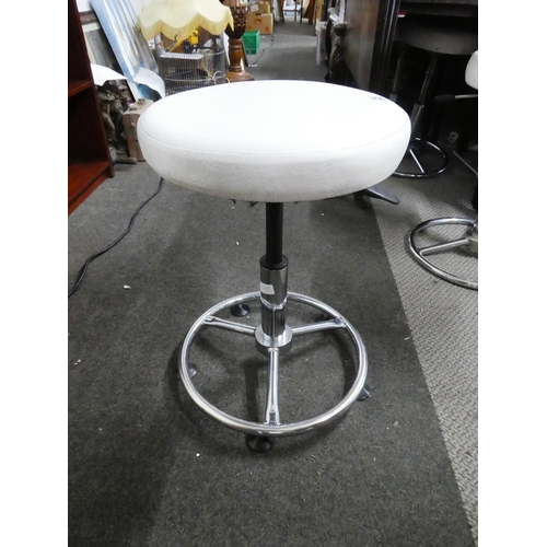 26 - A pair of leather topped swivel adjustable stools.