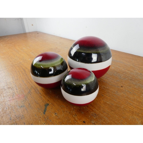 275 - Three ceramic ornamental balls.