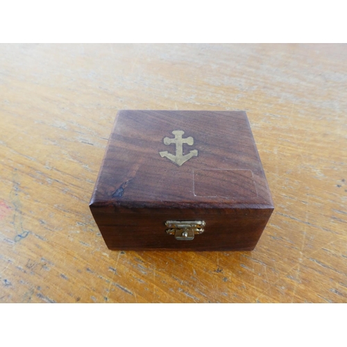 29 - A brass compass in an 'anchor' mahogany boxed.