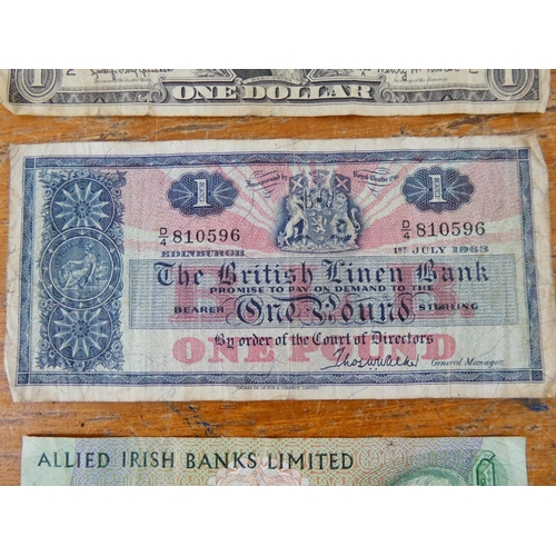 312 - A British Linen Bank one pound note, a United States of America one dollar note and more.