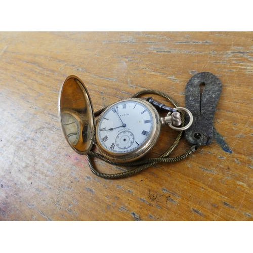 323 - An Elgin pocket watch and chain.