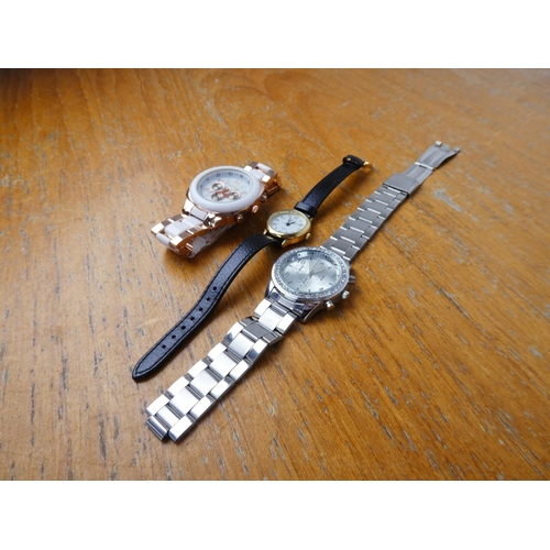 371 - A Michael Kors replica wrist watch and two others.