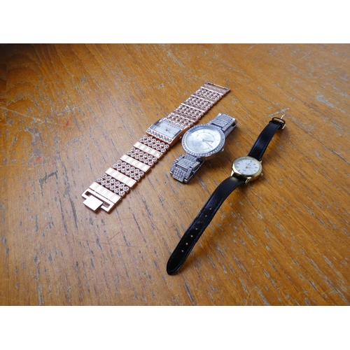 382 - A Guess replica wrist watch and two others.