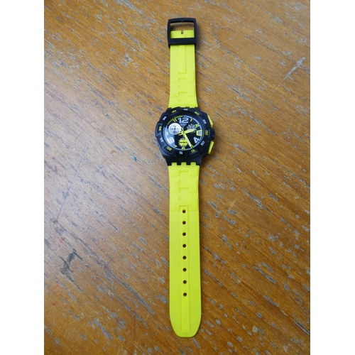 387 - A yellow Swatch wrist watch.