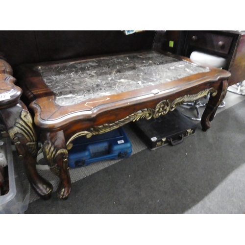 68 - A stunning large mahogany coffee table with carved detail and a marble effect top, measuring 49