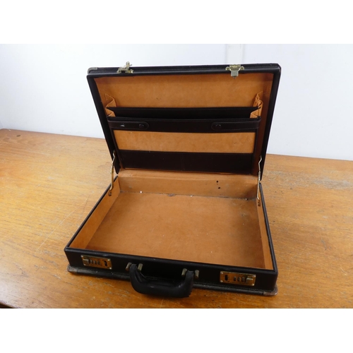 69 - A leatherette briefcase.