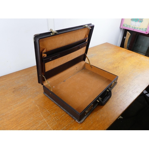 69 - A leatherette briefcase.