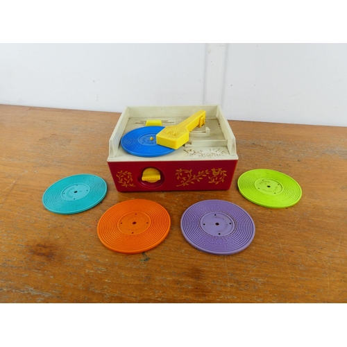 7 - A vintage Fisher Price music box record player and discs.