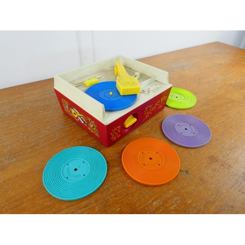 7 - A vintage Fisher Price music box record player and discs.