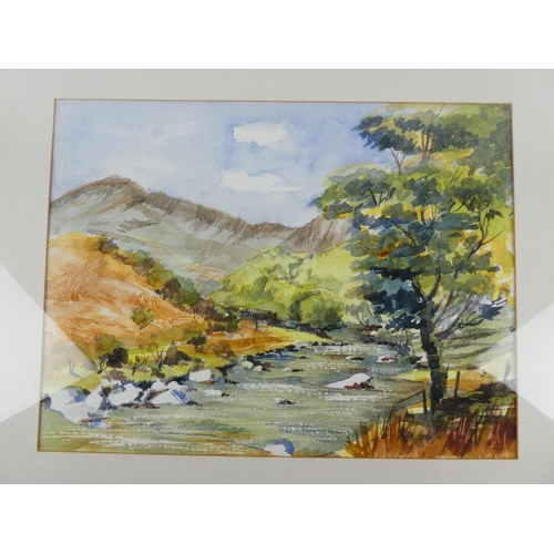 9 - A framed watercolour painting of a mountain scene.
