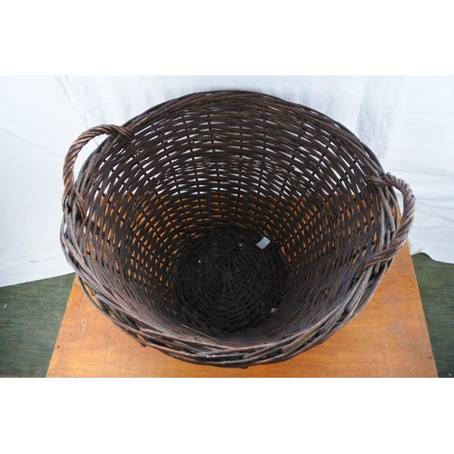 442 - A large wicker log basket, measuring 21