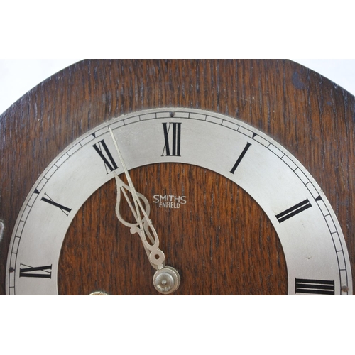 491 - A vintage Smiths oak cased mantle clock.