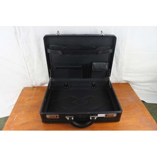 504 - A leatherette briefcase (combination 752).