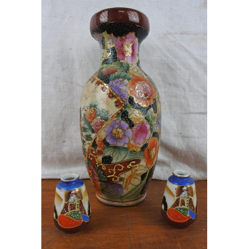 518 - An oriental style vase and a pair of miniature vases.