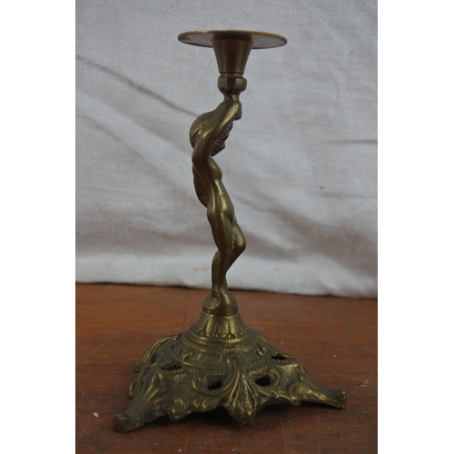 529 - A small brass cherub candlestick.