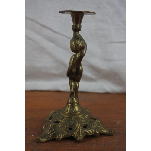 529 - A small brass cherub candlestick.