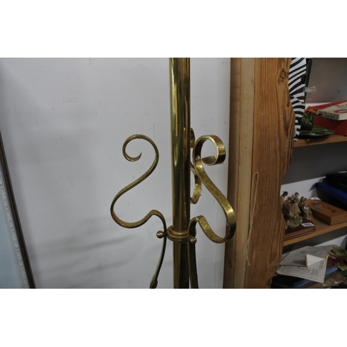 569 - A brass standard lamp and shade on tripod base, measuring 76