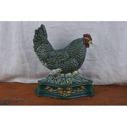 571 - A large hen cast iron doorstop