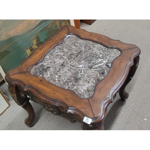 72 - A stunning mahogany occasional table with carved detail and a marble effect top, measuring 26