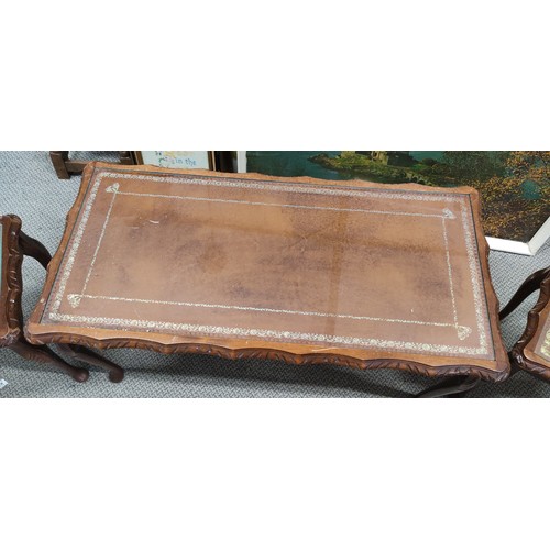 163 - A mahogany long nest of three tables with glass and leather top, measuring 37