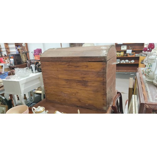 179 - A large dome shaped wooden storage trunk, measuring 36