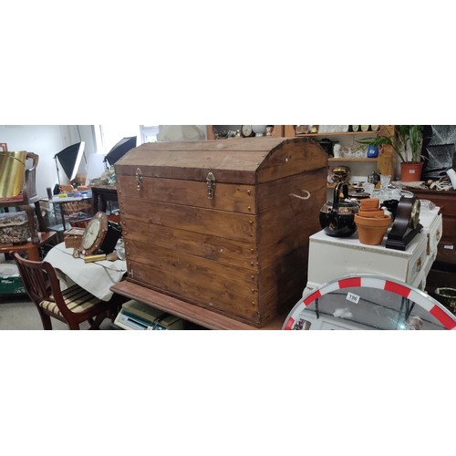 179 - A large dome shaped wooden storage trunk, measuring 36