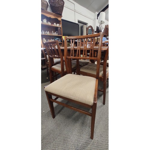 235 - A vintage/ Mid Century Teak drop leaf dining table with set of 6 matching chairs, measuring 58