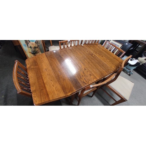 235 - A vintage/ Mid Century Teak drop leaf dining table with set of 6 matching chairs, measuring 58