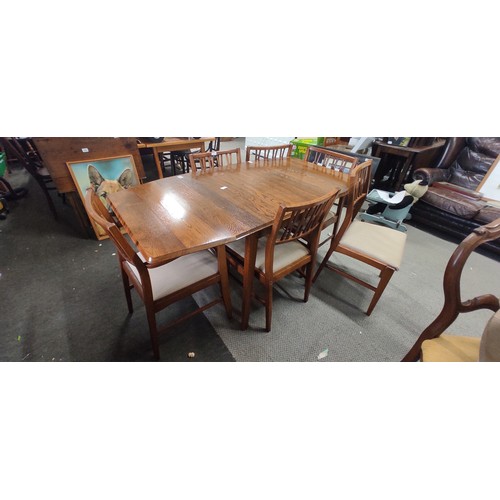 235 - A vintage/ Mid Century Teak drop leaf dining table with set of 6 matching chairs, measuring 58