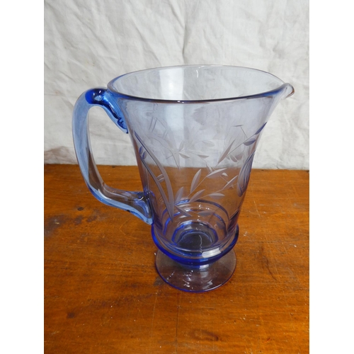 34 - A stunning vintage blue glass water jug.