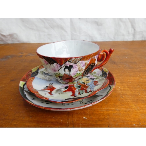 49 - A decorative Chinese/ Oriental cup, saucer and plate.