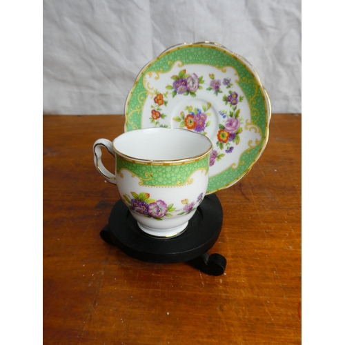 23 - A stunning Royal Albert Crown China miniature cabinet cup and saucer on a presentation stand.