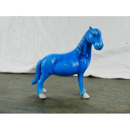 102 - A Highland Arts glazed pottery figure of a horse.